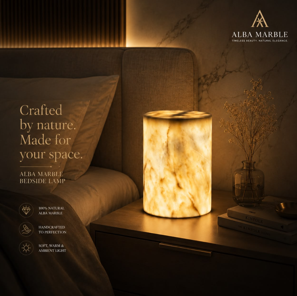 Alba Marble lamp glowing beside a luxury bed