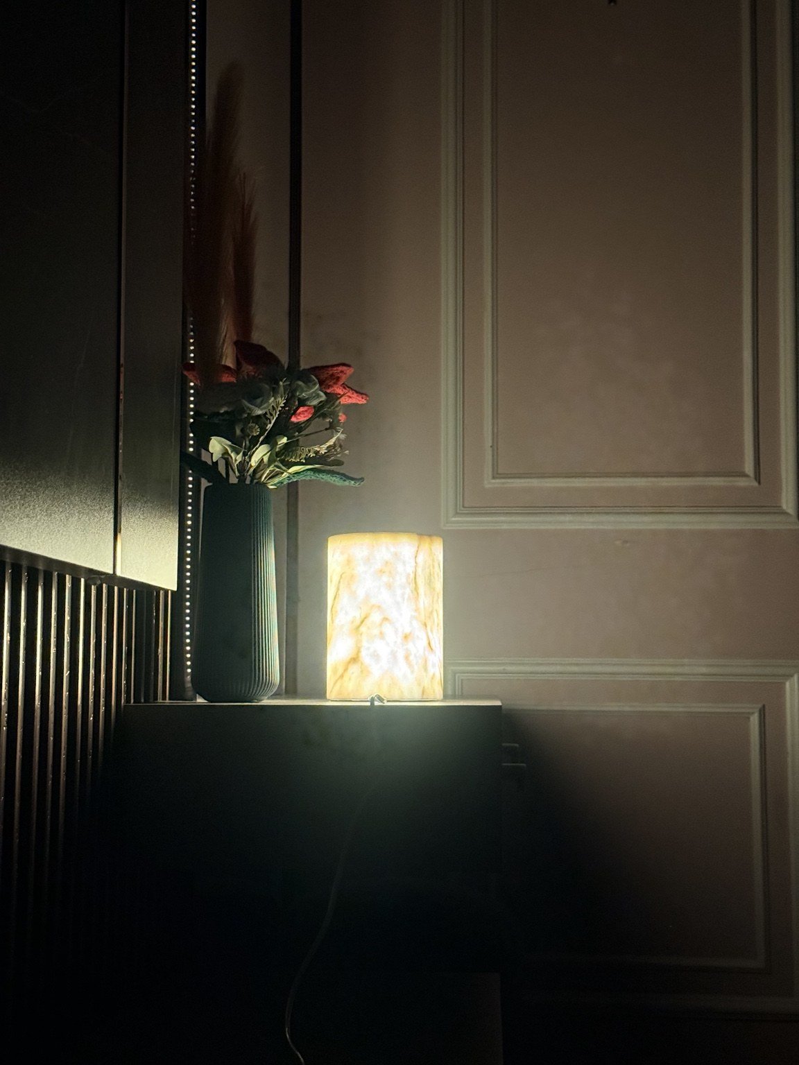 Alba Marble natural stone lamp glowing on a side table